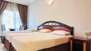 Postel nebo postele na pokoji v ubytování Dancenter San Marino Hotel