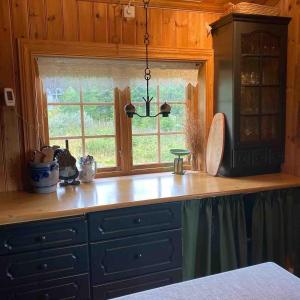 a kitchen with a sink and a window at Trollslottet på Skeikampen in Aulstad +32 photos