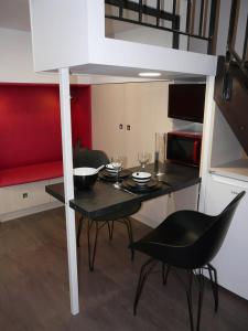 a room with a table and chairs and a loft bed at Le 12 Pierres - Croix-Rousse - Cosy & Design in Lyon