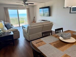 a living room with a couch and a table at Luxurious 67 Direct Oceanfront at Spanish Main in Cocoa Beach