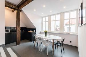 a kitchen and dining room with a table and chairs at LivingRoom 4B Loft self Check-in 24h in Katowice