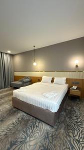 a bedroom with a large bed in a room at Ozen Palace Hotel in Almaty +28 photos