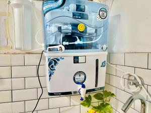 a water heater on a wall in a kitchen at The First Floor I Top Rated Boutique Homestay I Near Lekhraj Metro Lucknow in Lucknow
