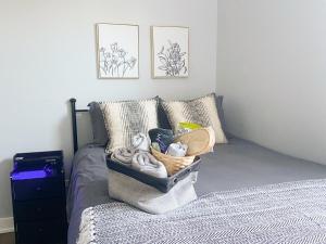 a bedroom with a bed with a basket of towels at Pristine 3bdr 2ba Condo UChicago in Chicago