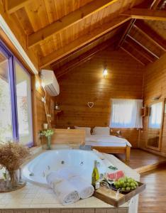 a bath tub in a room with a bed at The calm west in Liman