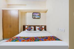 a bedroom with a bed with a colorful comforter at Via Prestige Castle - Nr HITEX Exhibition Center Hitech City in Hyderabad