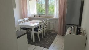 a kitchen with a table and chairs and a television at Ferienwohnung Am Lollbach in Bad Kissingen +7 photos