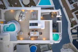 an overhead view of a house with a pool at Pura Vida Villa in Imerovigli