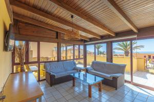 a living room with two chairs and a table at Granillo Escape in Costa Calma
