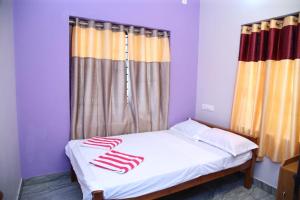 a bed with red and white towels on it at Heavens Manor in Trivandrum