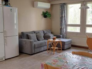 a living room with a couch and a refrigerator at Eurajoen opisto in Eurajoki