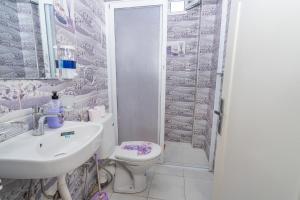 a bathroom with a toilet and a sink and a shower at Appartement Ensolleillé Au coeur De Tanger in Tangier +42 photos