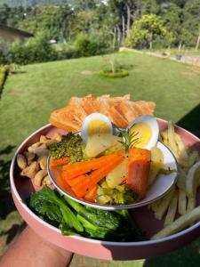 a bowl of food with eggs and vegetables and fries at The Chapter in Nuwara Eliya