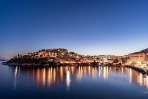 a large body of water with houses on a hill at Nefeli Hotel in Kavála