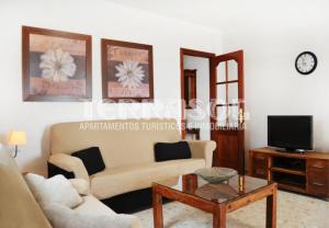 a living room with a couch and a coffee table at Terrasol Azucarera Atico H in Torre del Mar