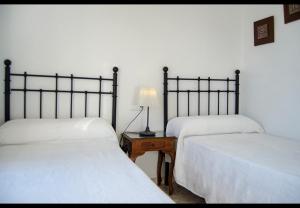 a bedroom with two beds and a lamp on a table at Terrasol Azucarera Atico H in Torre del Mar +20 photos