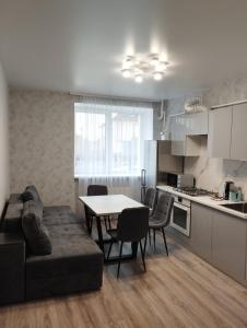 a living room and kitchen with a table and a couch at Яровиця 2 поверх Центр in Luts'k