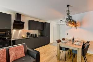 a kitchen and dining room with a table and chairs at Mazot de Kayla, Alpes Travel, Les Houches, Sleeps 4 in Les Houches