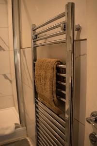 a towel hanging on a towel rack in a bathroom at Chic Brighton Studio in Brighton & Hove +22 photos