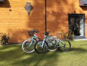 two bikes parked in front of a house at Domek pod sosnami in Ełk