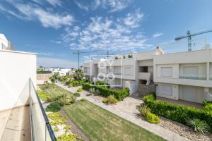 einen Blick vom Balkon eines weißen Apartmentgebäudes in der Unterkunft Design Apartment Flamenco Garden at La Finca Golf - By Oyoostays in Algorfa