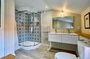 a bathroom with a toilet and a sink and a shower at The Globe Inn in Wells next the Sea +37 photos