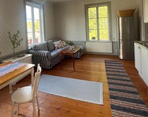 a living room with a couch and a table at Norrgården Hälsingland in Vallsta