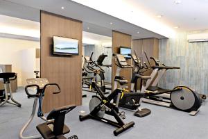 a gym with a bunch of exercise bikes and treadmills at Bayfront Hotel Cebu North Reclamation in Cebu City