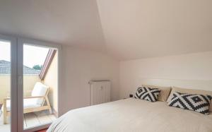 a white bedroom with a bed and a window at EnJoy Home - Padova Pop Terrace in Padova