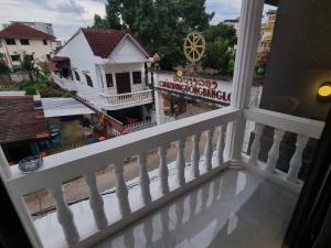 a balcony with a white railing and a view of a town at Lunar Hostel in Vientiane