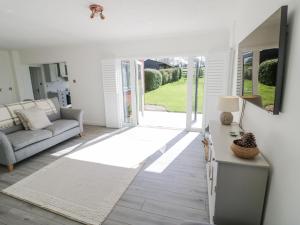 a living room with a couch and a table at New House Farm in Leamington Spa