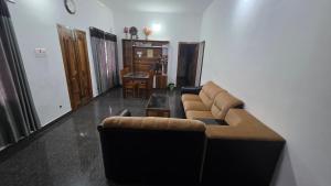 a living room with a couch and a table at Serahs Homestay in Agali