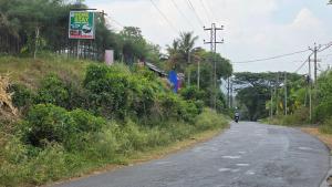 a person riding a motorcycle down a road at Serahs Homestay in Agali