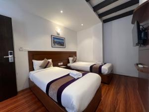 Ένα ή περισσότερα κρεβάτια σε δωμάτιο στο Hotel New Era