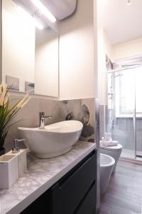 a white bathroom with a sink and a toilet at PrimoPiano - Padova 217A in Milan +42 photos