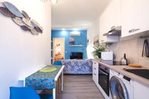 a kitchen and living room with a washer and dryer at PrimoPiano - Padova 217A in Milan