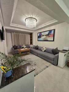 a living room with a couch and a table at Chic 2BR Apt - Walk to Beach in Essaouira