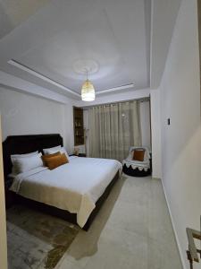 a bedroom with a large bed and a window at Chic 2BR Apt - Walk to Beach in Essaouira