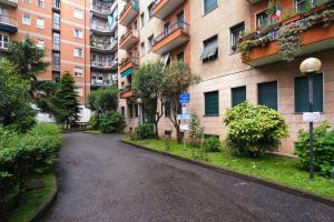 an empty street in front of an apartment building at PrimoPiano - Padova 217A in Milan
