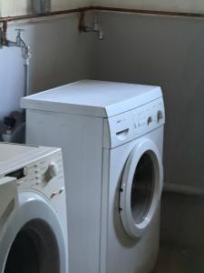 La salle de bains est pourvue d'un lave-linge et d'un sèche-linge blancs. dans l'établissement Ferienwohnung-Montagewohnunng DO, à Dortmund 1 autre photo