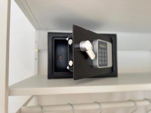 a phone on a shelf in a room at Dream Stay Nettuno in Nettuno