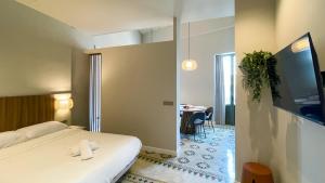a hotel room with a bed and a table at Heritage apartamentos in Villajoyosa