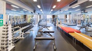 a gym with rows of benches and tread machines at Beachfront Getaway in Torquay