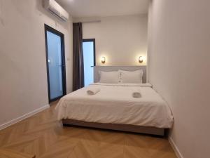 a bedroom with a large bed with two windows at Lunar Hostel in Vientiane +20 photos