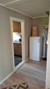 a kitchen with a white refrigerator in a room at Apartment in the heart of Sunnmore in Vigra