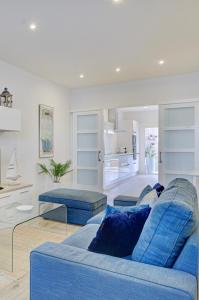 a living room with two blue couches in a room at CASA MIMAR moderna y acogedora in La Oliva +27 photos