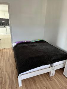 a bed sitting in a corner of a room at Ferienwohnung Schickling in Großenlüder