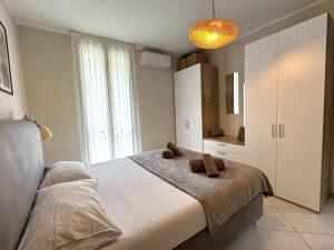 a bedroom with a large bed and a large window at Like Heaven Argegno Pool & Lake View in Argegno