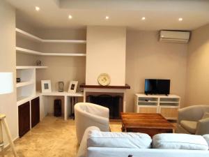 a living room with a couch and a fireplace at Casa Playa Las Redes in El Puerto de Santa María