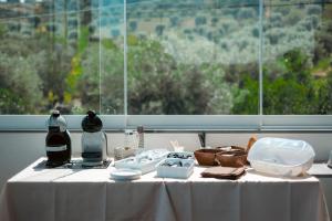 a table with a white table cloth and a window at LM HOME Crosia in Mirto